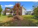 View of the backyard featuring a storage shed, deck and tree with a pile of branches at 499 Folly Estates Dr., Myrtle Beach, SC 29588