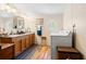 Functional bathroom featuring double sinks, wood cabinetry, and a modern washing machine at 499 Folly Estates Dr., Myrtle Beach, SC 29588