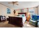 Bright bedroom featuring a cozy chair, a ceiling fan, and a wood bed frame at 499 Folly Estates Dr., Myrtle Beach, SC 29588
