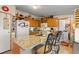 Kitchen with granite countertop island, updated appliances, and wood cabinets at 499 Folly Estates Dr., Myrtle Beach, SC 29588