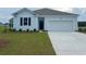 Charming single-story home featuring board and batten siding, a two-car garage, and a well-manicured lawn at 5175 Yellowstone Dr., Conway, SC 29526