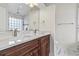 Bathroom with double vanity, granite countertop, and marble tiling in the shower and on the floor at 601 Seth Ln., Longs, SC 29568