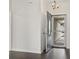 A bright entryway with an open front door features wood flooring and a modern light fixture at 601 Seth Ln., Longs, SC 29568