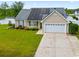 Attractive home with solar panels, lush landscaping, and a two-car garage at 601 Seth Ln., Longs, SC 29568