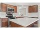 A stainless steel microwave above a stove and white countertops at 601 Seth Ln., Longs, SC 29568