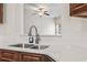 A stainless steel sink with white countertops and wooden cabinets at 601 Seth Ln., Longs, SC 29568