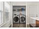 Convenient laundry closet featuring modern washer and dryer, plus shelving for supplies at 601 Seth Ln., Longs, SC 29568