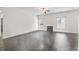 An empty living room with dark floors and windows overlooking the backyard at 601 Seth Ln., Longs, SC 29568