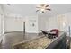 Large living room with wood floors, rug, furniture, and a pass-through to the stainless steel kitchen appliances at 601 Seth Ln., Longs, SC 29568