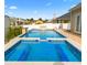 A beautiful private swimming pool with stone waterfall feature and spa is surrounded by a fence and deck at 601 Seth Ln., Longs, SC 29568