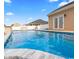Inviting pool area with clear blue water and a stone waterfall feature, perfect for summer relaxation and outdoor fun at 601 Seth Ln., Longs, SC 29568
