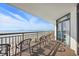 Ocean view from the condo balcony, complete with chairs and a table at 7200 N Ocean Blvd. # 1053, Myrtle Beach, SC 29572