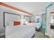 Bright bedroom featuring two beds with red pillows, soft curtains, and a view to the vending machines outside at 7200 N Ocean Blvd. # 1053, Myrtle Beach, SC 29572
