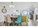 Bright dining area features table, chairs, stylish lighting, beachy decor, and access to a balcony with ocean views at 7200 N Ocean Blvd. # 1053, Myrtle Beach, SC 29572