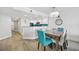 Bright dining area with modern table set and stylish light fixture, complemented by a clean, open kitchen design at 7200 N Ocean Blvd. # 1053, Myrtle Beach, SC 29572