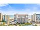 Wide view of the condo complex on the beach with an attached parking garage and blue skies at 7200 N Ocean Blvd. # 1053, Myrtle Beach, SC 29572