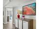 Inviting hallway features modern console table with decorative lamp, artwork, and access to well-appointed bedroom at 7200 N Ocean Blvd. # 1053, Myrtle Beach, SC 29572