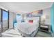 Bright main bedroom boasts private balcony with ocean views, comfortable king bed, and beach-themed decor at 7200 N Ocean Blvd. # 1053, Myrtle Beach, SC 29572