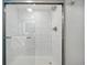 Modern bathroom shower with white marble style tiles and modern fixtures at 7200 N Ocean Blvd. # 1053, Myrtle Beach, SC 29572