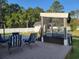 Backyard patio with chairs, privacy screen, and lush greenery at 7473 Louisville Rd., Aynor, SC 29511