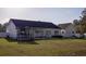Exterior of a home with a nice backyard, patio, and hot tub at 7473 Louisville Rd., Aynor, SC 29511
