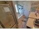 Bright bathroom features a tub, glass-enclosed shower, and a white double vanity, perfect for comfortable living at 7473 Louisville Rd., Aynor, SC 29511