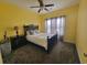 Spacious bedroom boasts a ceiling fan and plush carpet, offering a cozy retreat within the home at 7473 Louisville Rd., Aynor, SC 29511