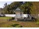 Charming exterior of the building featuring a garden, black fence, white fence, and abundant trees at 7473 Louisville Rd., Aynor, SC 29511