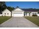 Charming single-story home boasts a spacious driveway and inviting front porch at 7473 Louisville Rd., Aynor, SC 29511