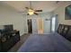 The main bedroom offers a ceiling fan, closet, and a mounted television at 7473 Louisville Rd., Aynor, SC 29511