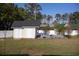 Charming shed with a door and an arbor, offering storage space and adding character to the property at 7473 Louisville Rd., Aynor, SC 29511