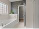 Bathroom with a soaking tub, glass shower, and decorative accent wall at 826 Sand Binder Dr., Myrtle Beach, SC 29579