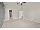 Spacious bedroom with a tray ceiling, ceiling fan, and neutral carpet at 826 Sand Binder Dr., Myrtle Beach, SC 29579