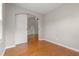 Bedroom with hardwood floors, sliding barn door, neutral walls, and view into a spacious living room at 826 Sand Binder Dr., Myrtle Beach, SC 29579