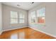 Cozy bedroom with hardwood floors, three windows offering natural light and a serene view at 826 Sand Binder Dr., Myrtle Beach, SC 29579