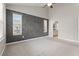 Bedroom with large windows, carpet flooring, and modern accent wall at 826 Sand Binder Dr., Myrtle Beach, SC 29579