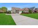 Charming single-story home showcasing a well-manicured lawn, long driveway, and inviting curb appeal at 826 Sand Binder Dr., Myrtle Beach, SC 29579