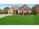 Charming single-story home featuring a well-manicured lawn and inviting curb appeal with mature landscaping at 826 Sand Binder Dr., Myrtle Beach, SC 29579