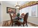 Dining room with glass table, decorative rug, palm tree art and chandelier lighting at 10100 Lakeshore Dr. # C-1, Myrtle Beach, SC 29572