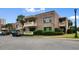 Brick condo building with small second-story balconies and golf cart parking at 10100 Lakeshore Dr. # C-1, Myrtle Beach, SC 29572