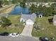 Aerial view of a charming home with a well-manicured front lawn, a long driveway, and a nearby lake at 105 Windsor Springs Rd., Conway, SC 29526