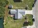 Aerial view of home with fenced yard, back patio, mature trees, and serene lake backdrop at 105 Windsor Springs Rd., Conway, SC 29526