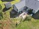 Aerial view of a house with a fenced yard, patio, and shed, nestled in a lush, green environment at 105 Windsor Springs Rd., Conway, SC 29526