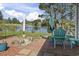 A comfortable patio area with an umbrella, serene lake views, and well-maintained landscaping at 105 Windsor Springs Rd., Conway, SC 29526