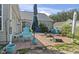 Well-designed patio with outdoor seating, landscaping, and sliding doors to a green home at 105 Windsor Springs Rd., Conway, SC 29526