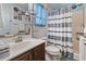 Cozy bathroom with gray and white striped shower curtain, modern fixtures, and ample lighting, creating a clean and stylish space at 105 Windsor Springs Rd., Conway, SC 29526