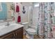 Nautical-themed bathroom featuring a vanity with a white sink, toilet, tub and shower with sea-inspired curtain at 105 Windsor Springs Rd., Conway, SC 29526
