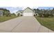 Traditional style home with a long driveway leading up to an attached two-car garage and well manicured front lawn at 105 Windsor Springs Rd., Conway, SC 29526