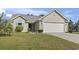 Charming home showcasing manicured lawn, complemented by turquoise shutters and a two-car garage at 105 Windsor Springs Rd., Conway, SC 29526