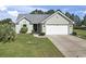 Charming single-story home with a manicured lawn, attached garage, and inviting curb appeal at 105 Windsor Springs Rd., Conway, SC 29526